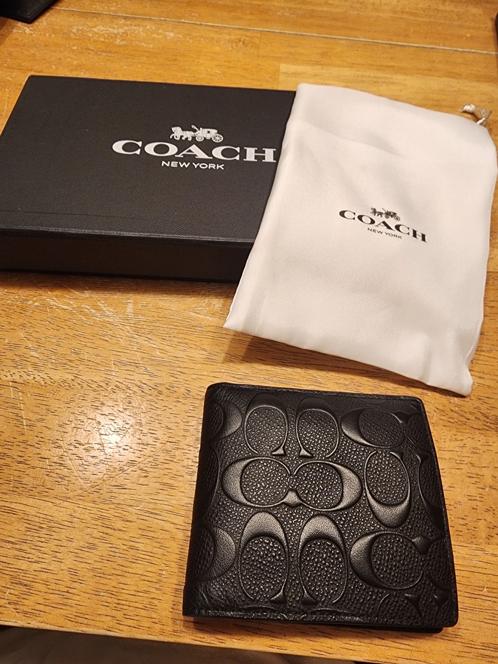 black leather Coach bifold coin wallet
